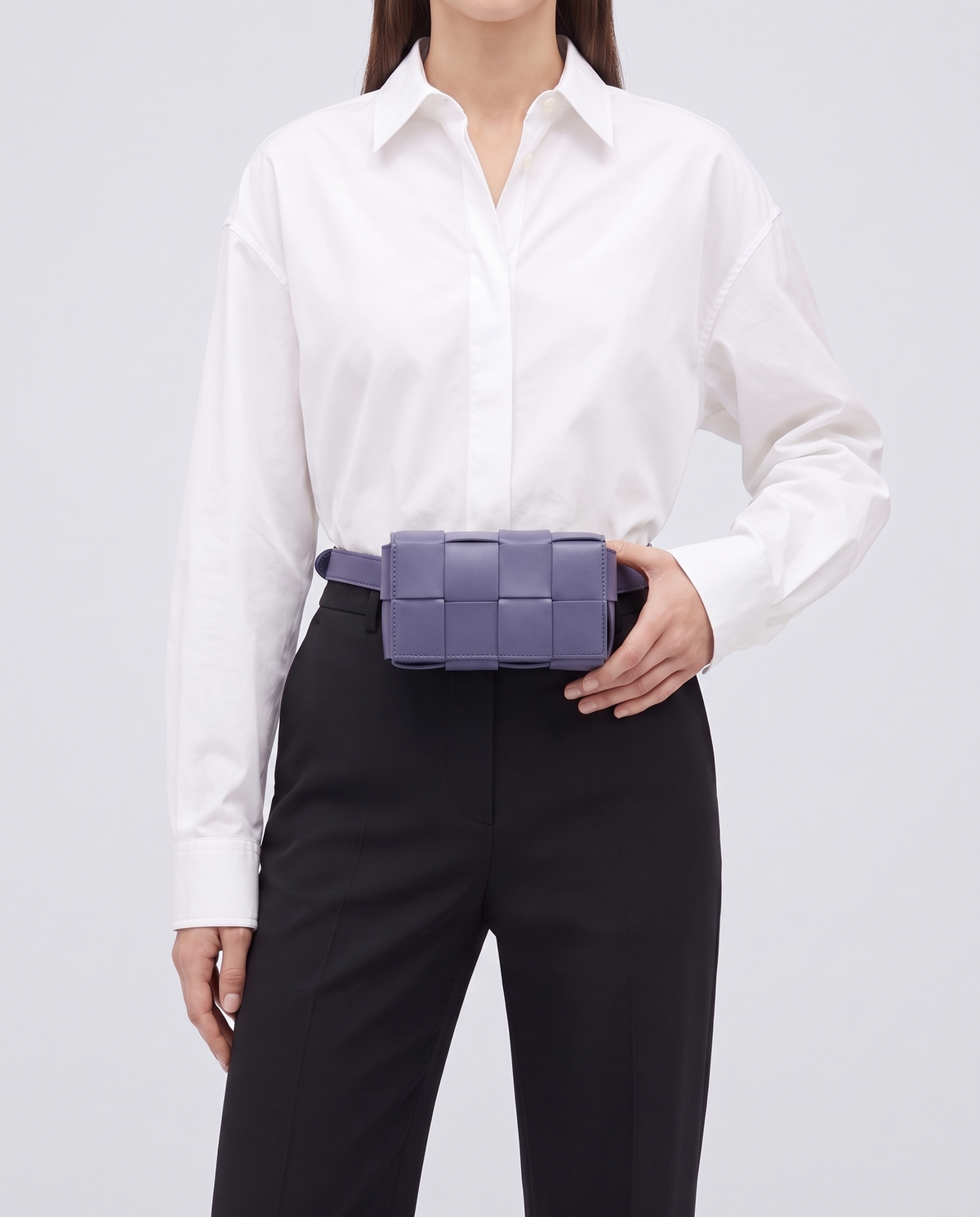 Cassette padded woven leather belt bag in Purple – model wearing it at the waist