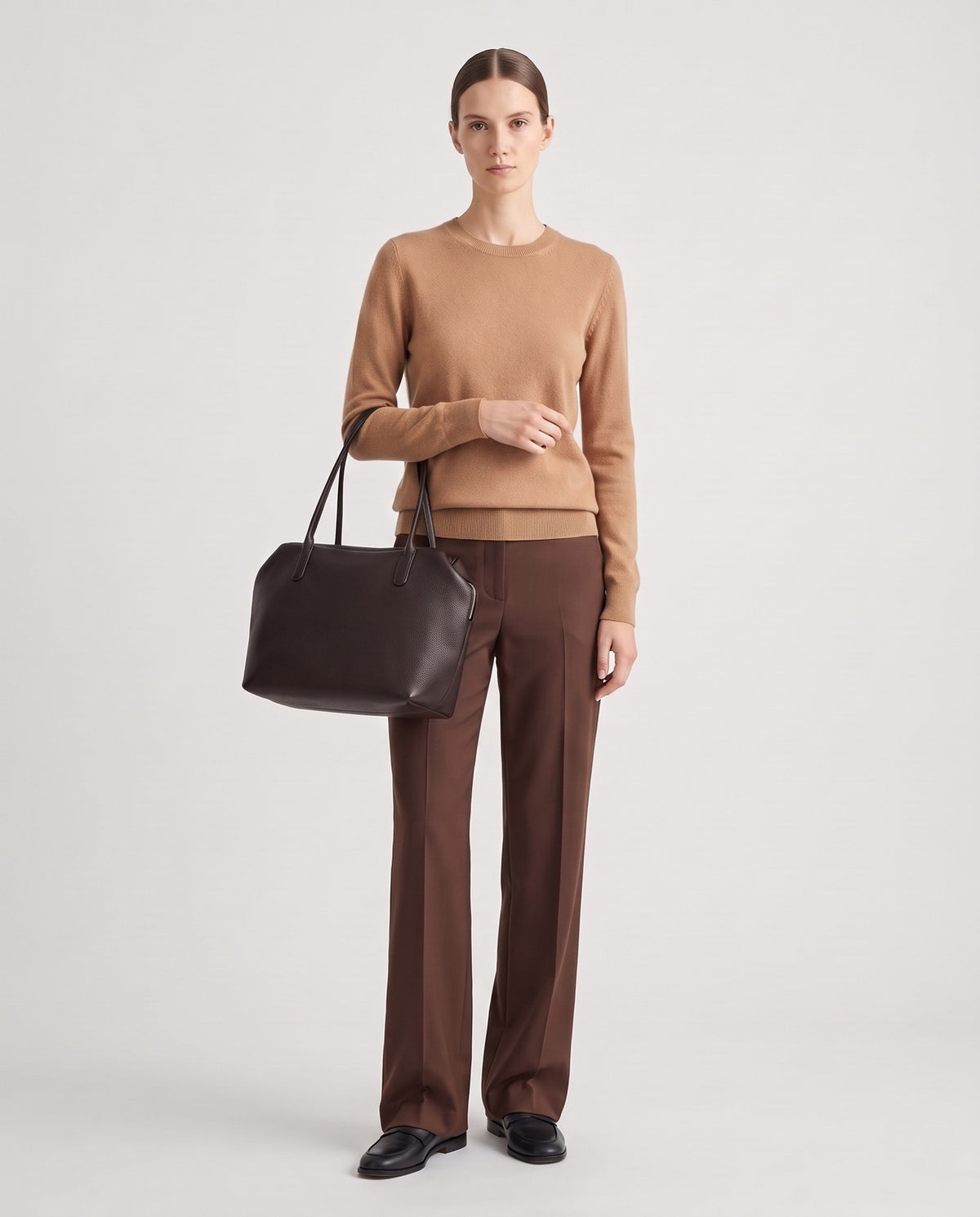 Pavia leather tote in Chocolate – model holding it, full length