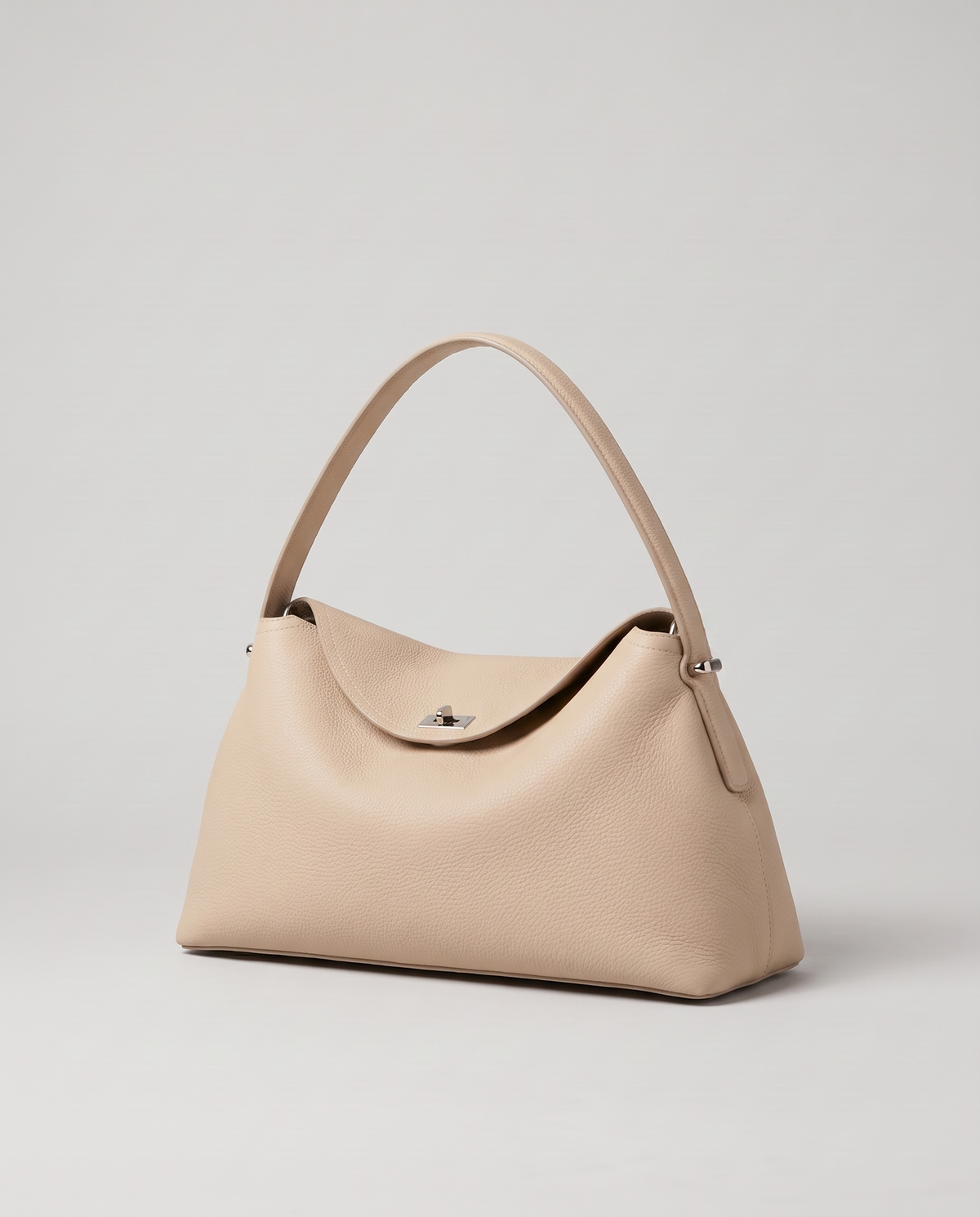 Porto pebbled leather top-handle bag in beige, three-quarter view