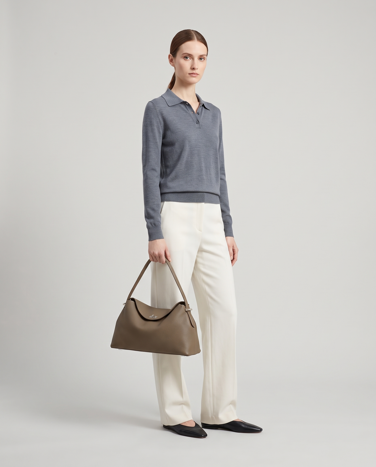 Model holding the Porto top-handle bag in taupe, full length