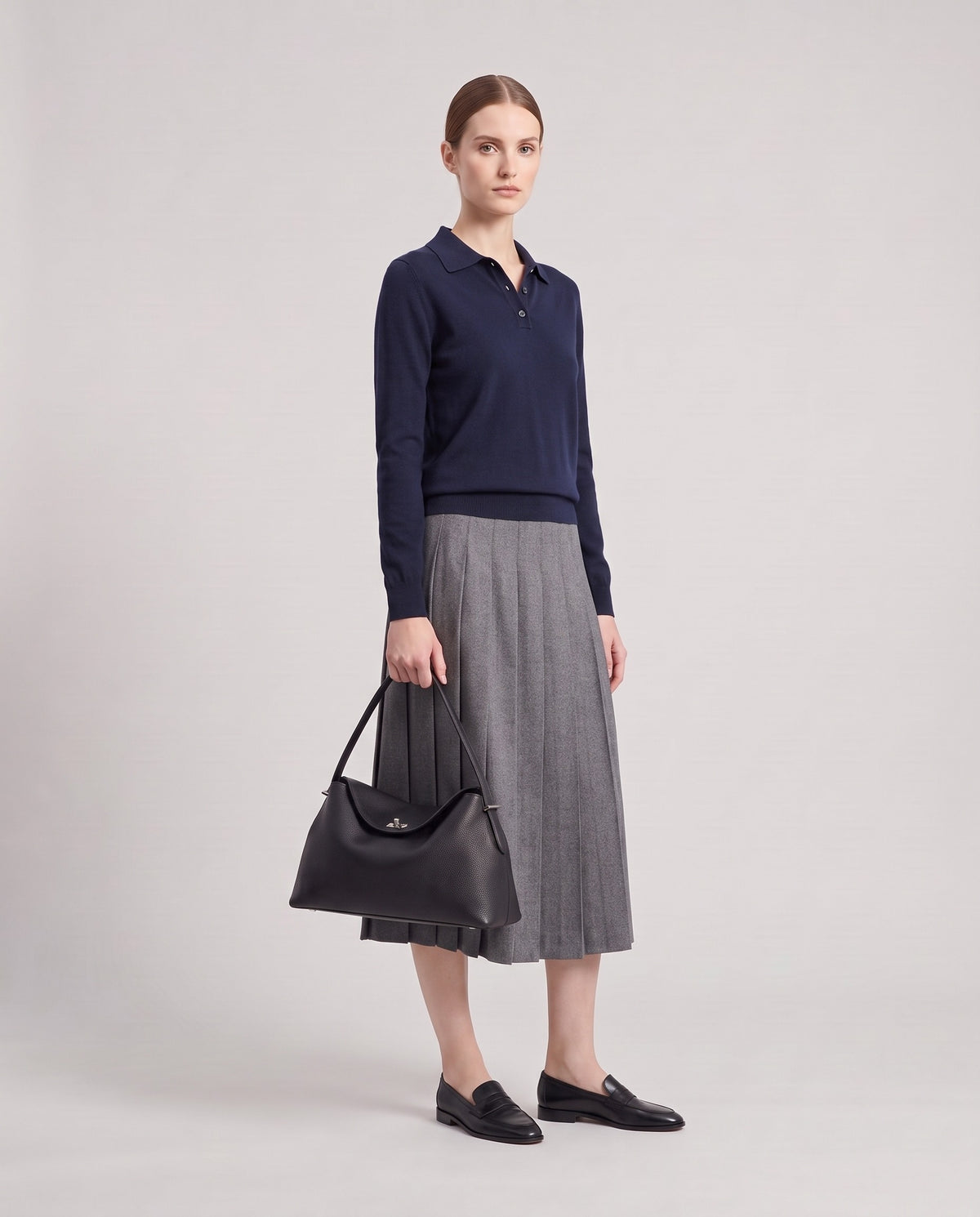 Model holding the Porto top-handle bag in black, full length