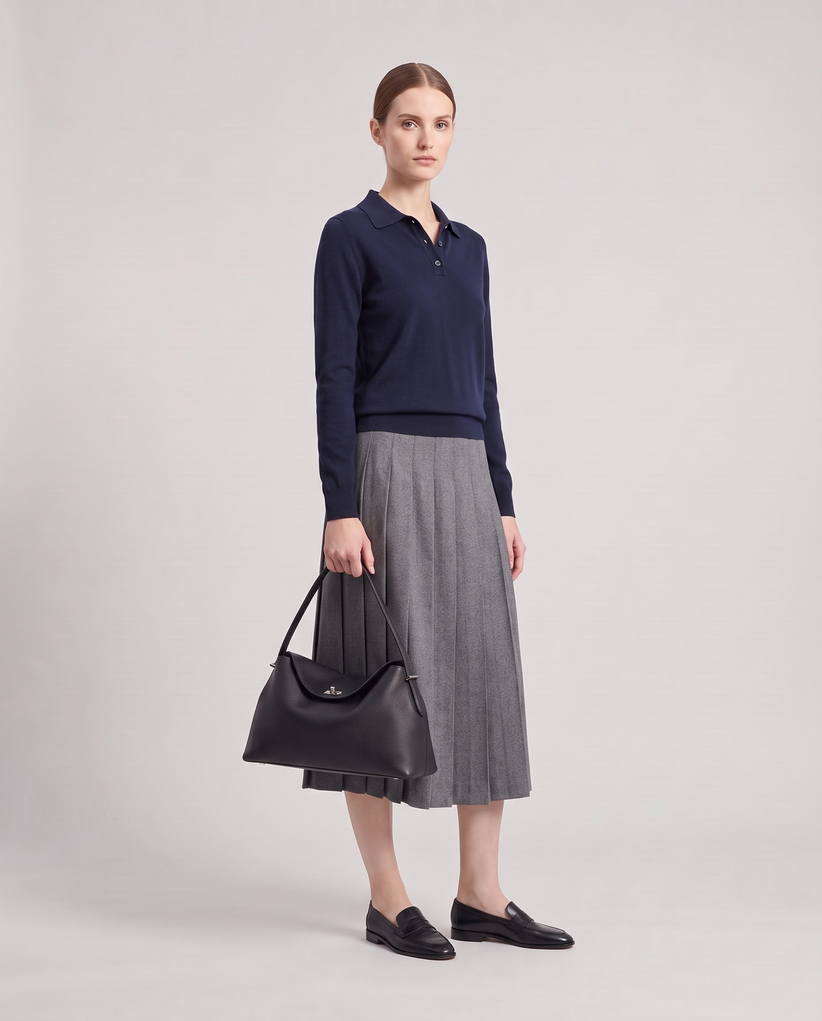Model holding the Porto top-handle bag in black, full length