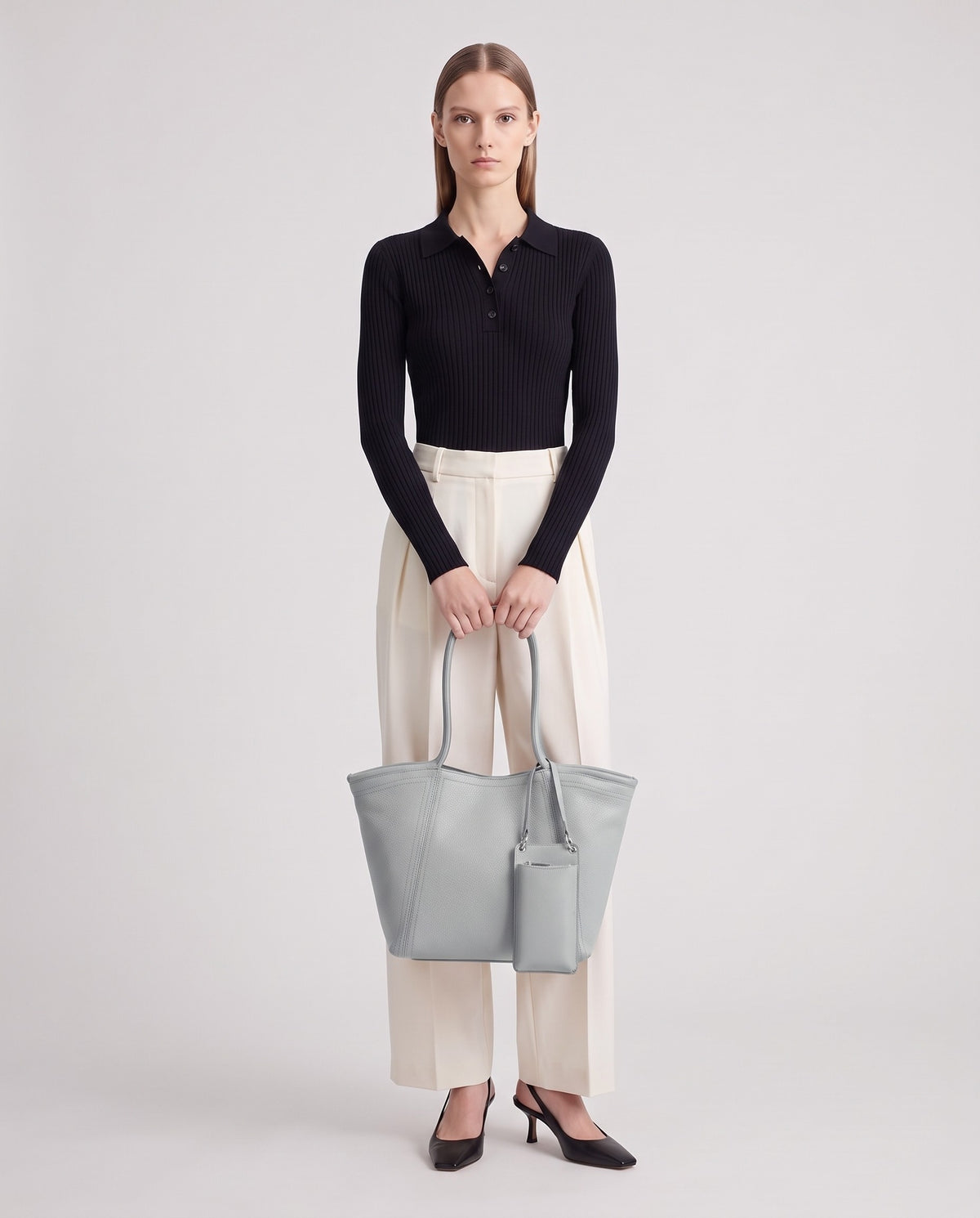 Prima leather tote in Grey – model holding it, full length