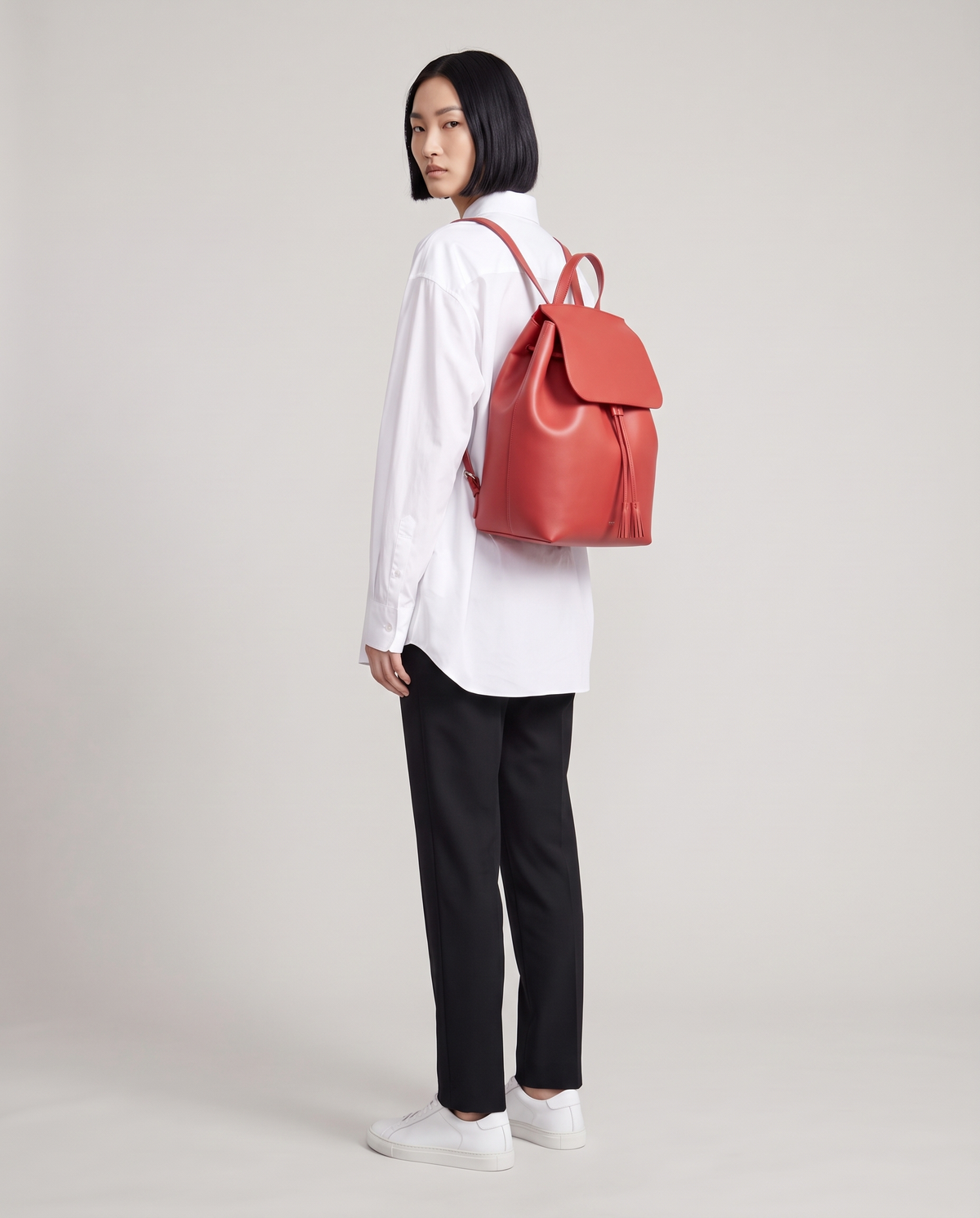 Roam Large leather backpack in Red – model wearing it on her back, full length