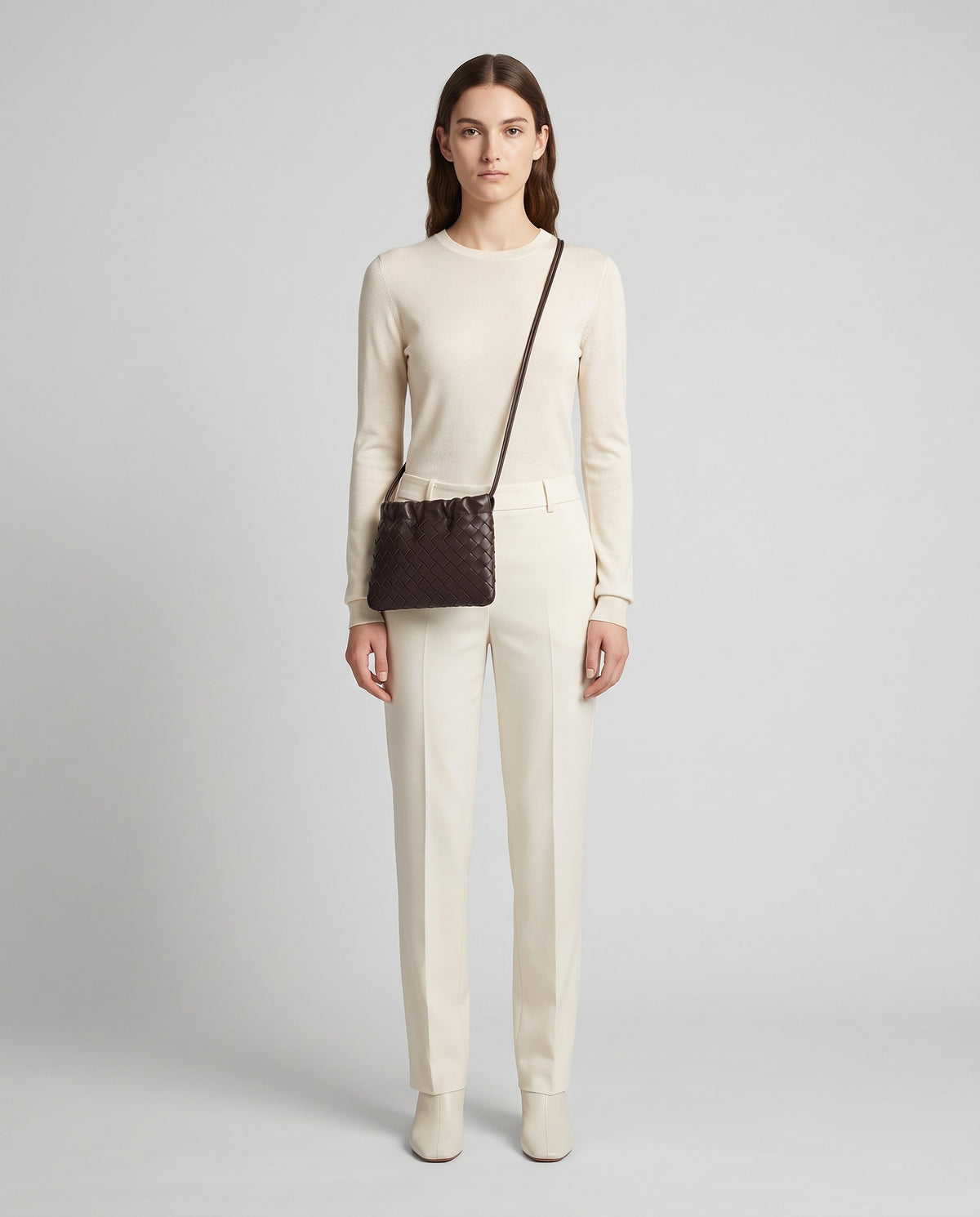 Serata woven leather clutch in Espresso – model wearing it, full length