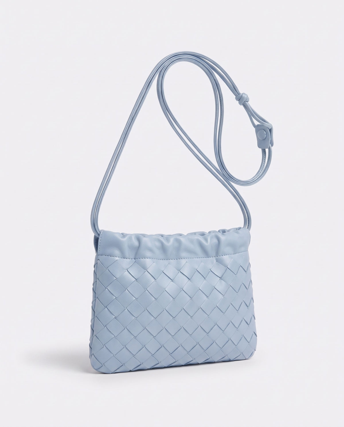 Serata woven leather clutch in Sky – three-quarter view
