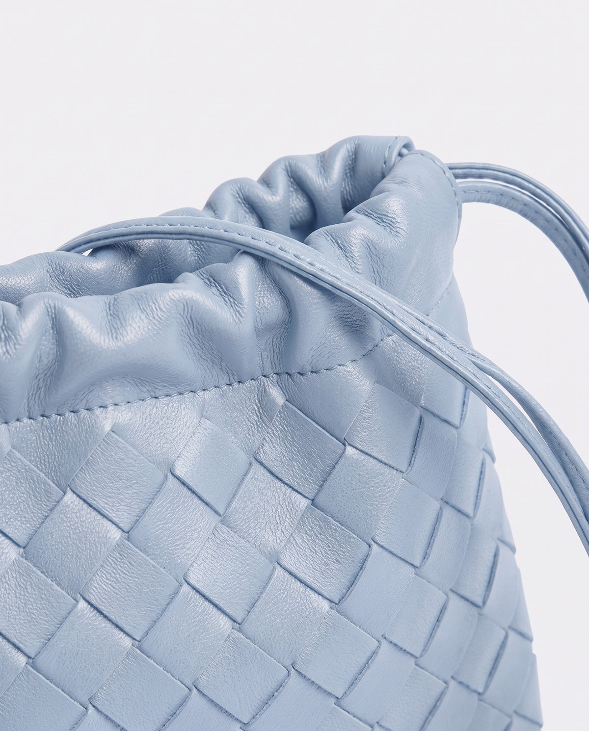 Serata woven leather clutch in Sky – drawstring detail