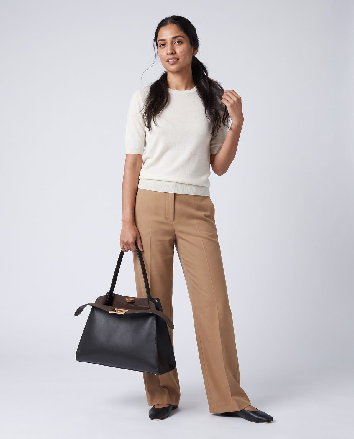 Model carrying the Siracusa leather bag in Black – full length