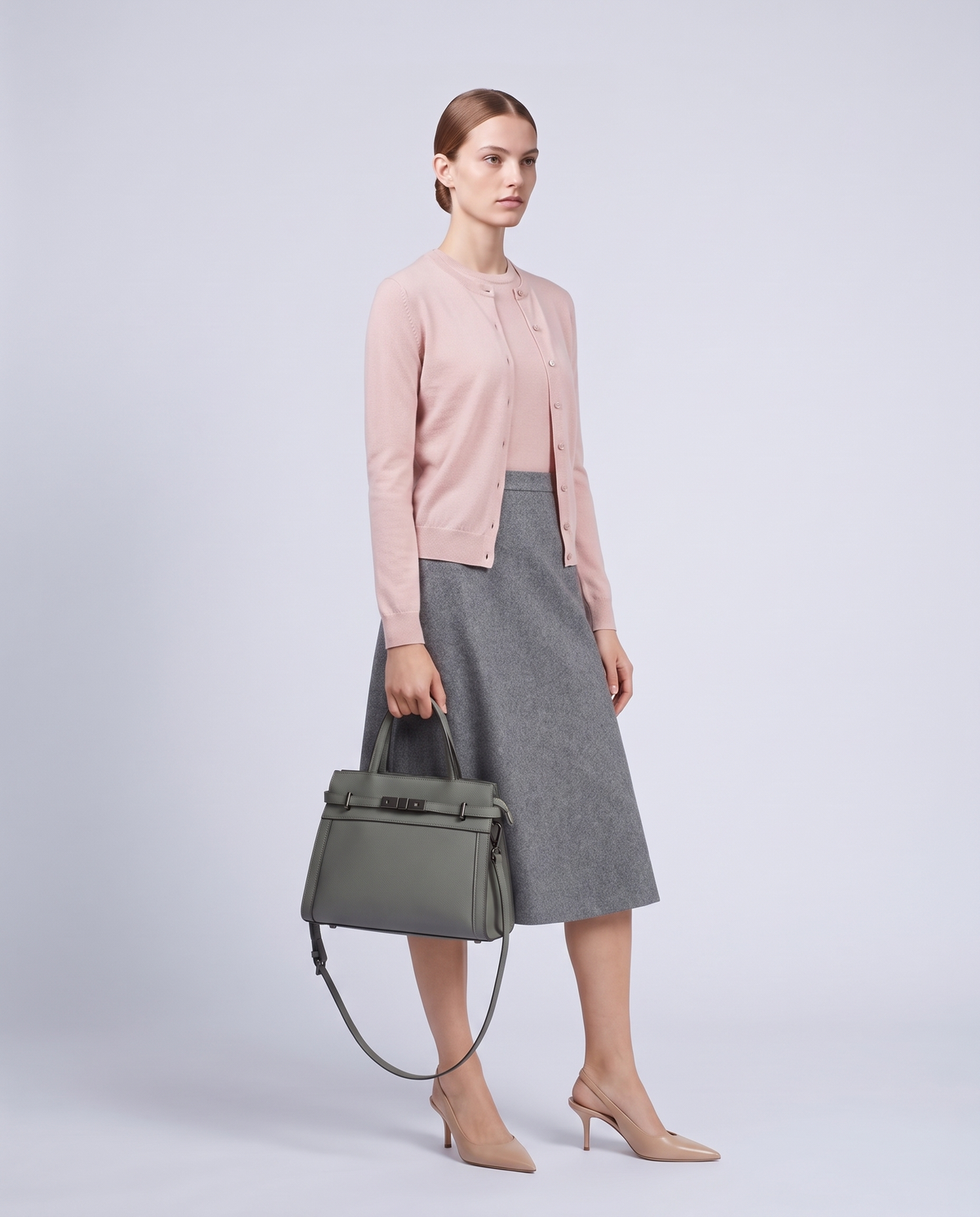 Model carrying the Taormina leather bag in Sage – full length