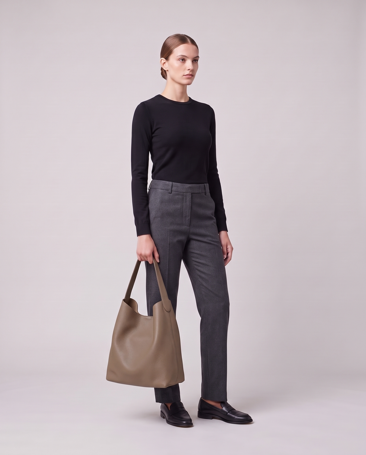 Model holding the Valentina Tela Small bag in Taupe, full length
