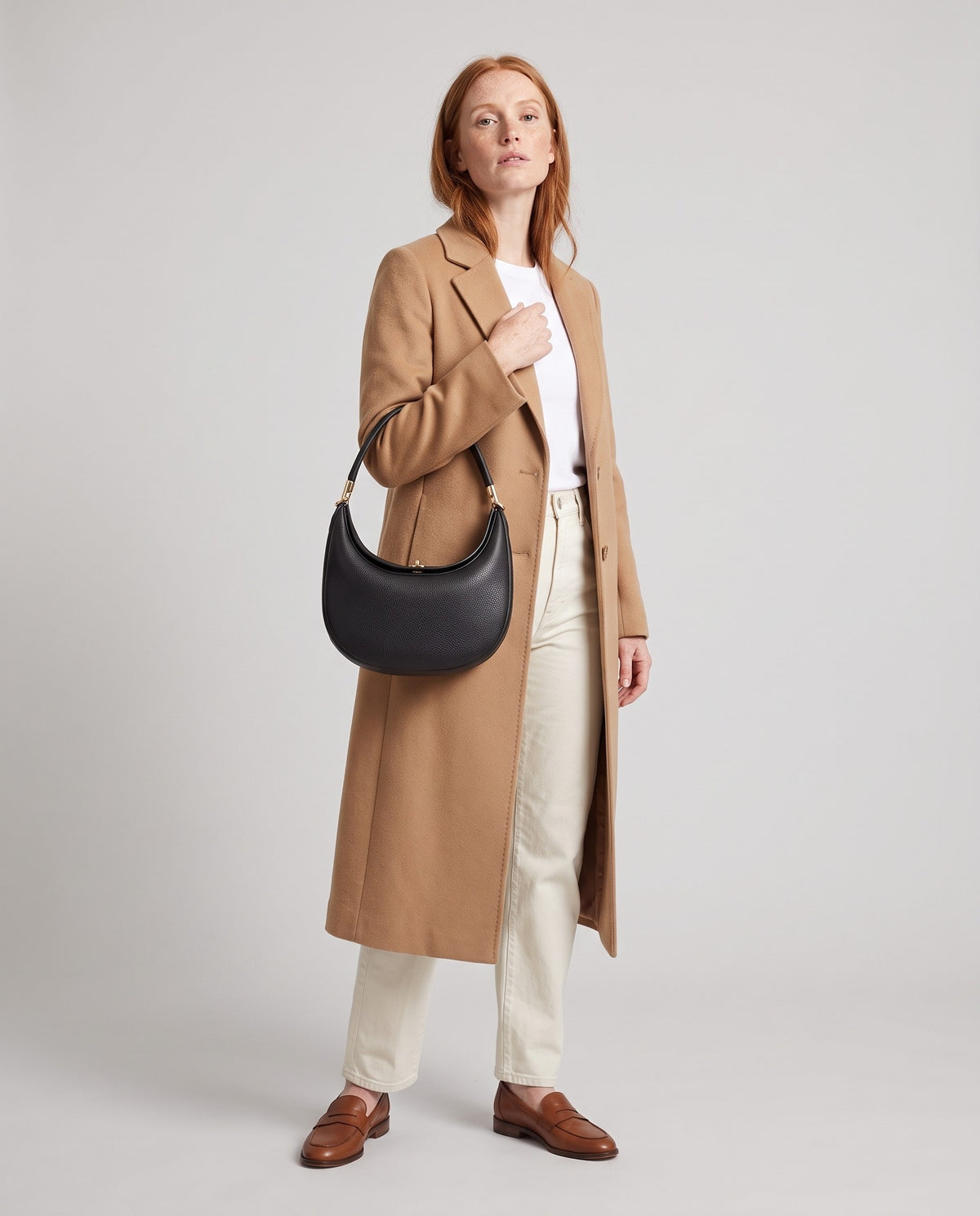 Model wearing the Todi crescent bag in Black – full-length view