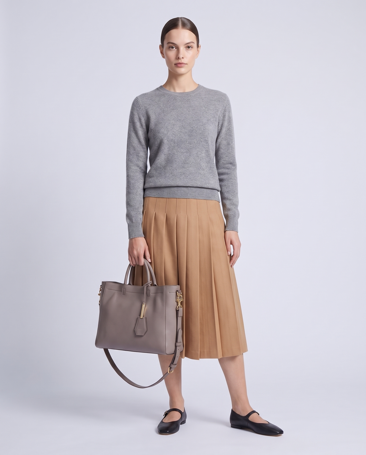 Model carrying the Torre small leather tote in Grey – full length