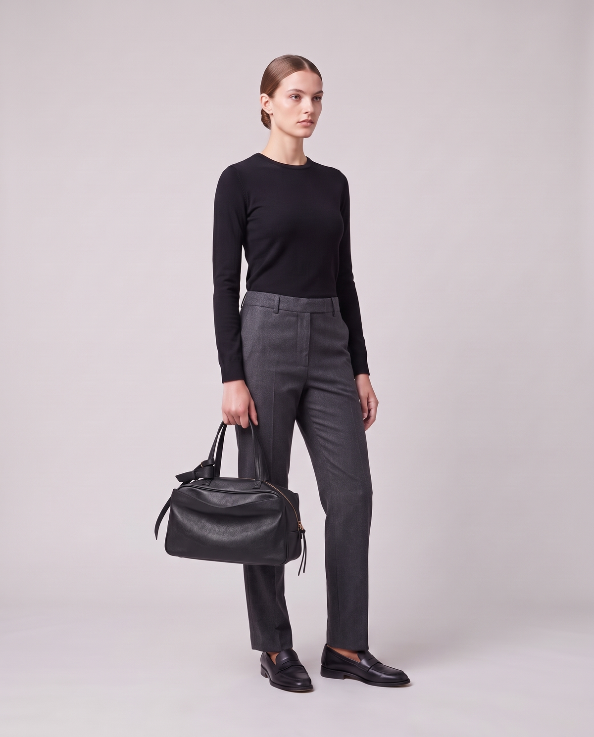 Model holding the Valentina Treviso Small bag in Black, full length