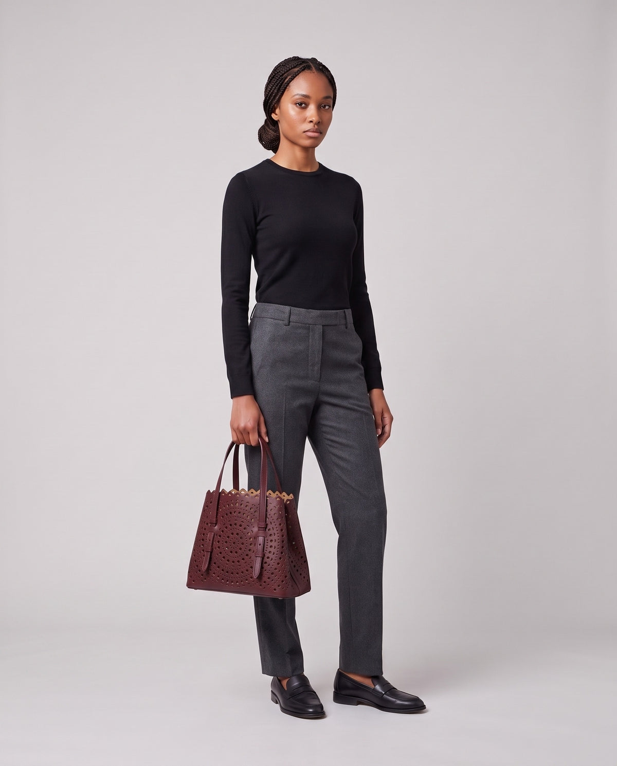 Model holding the Valentina Urbino Large bag in Burgundy, full length