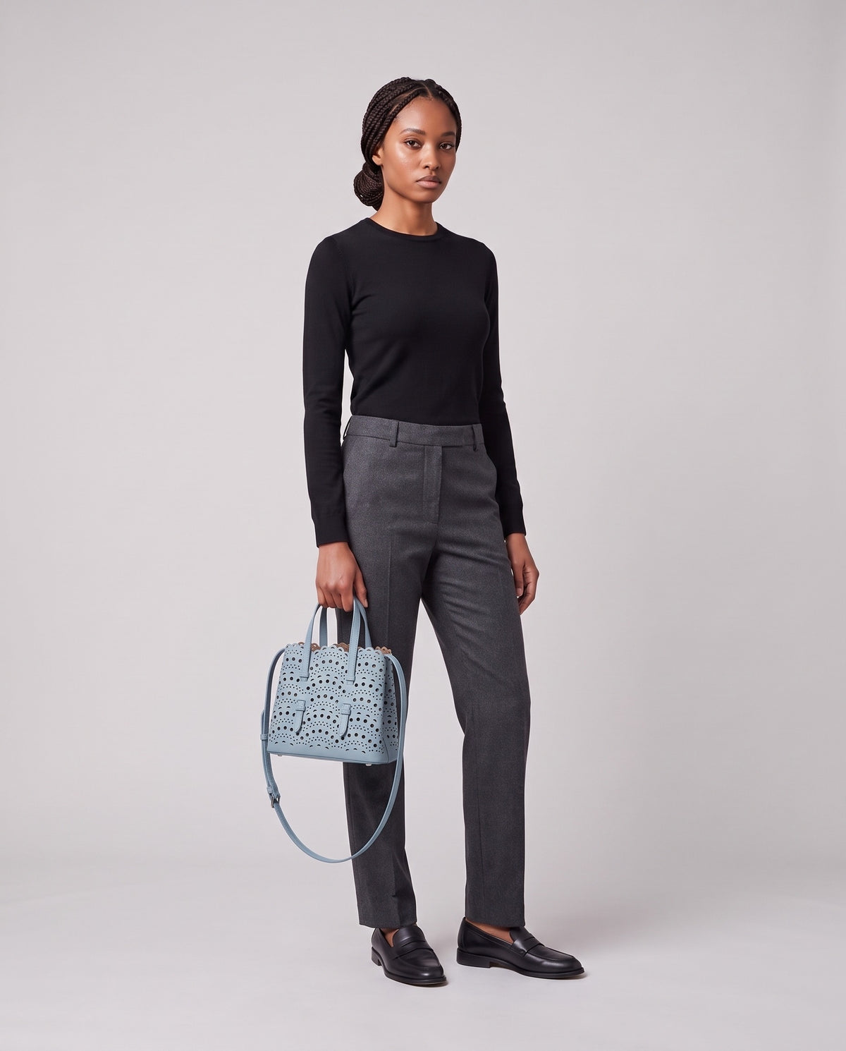 Model holding the Valentina Urbino Large bag in Sky, full length
