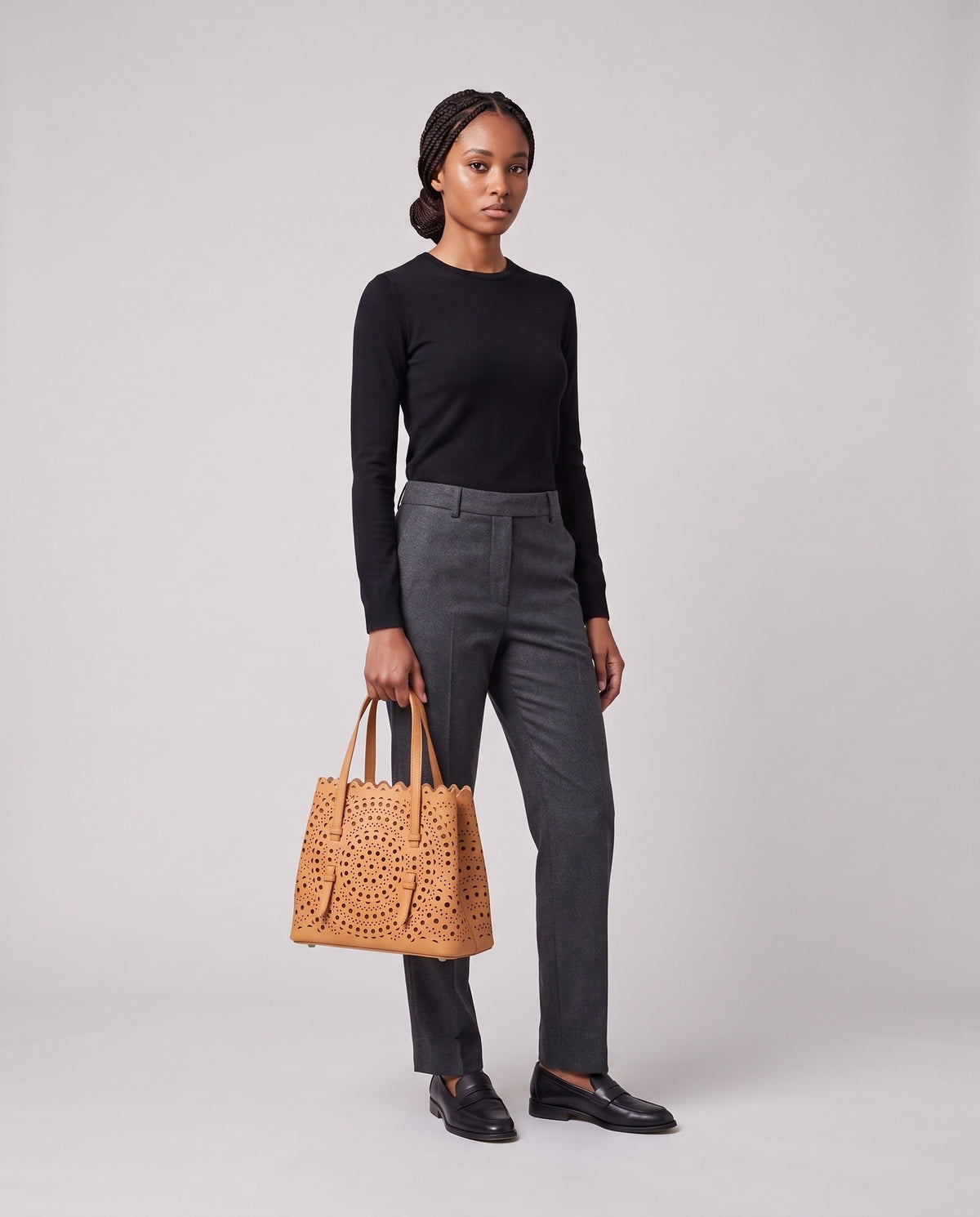 Model holding the Valentina Urbino Small bag in Apricot, full length