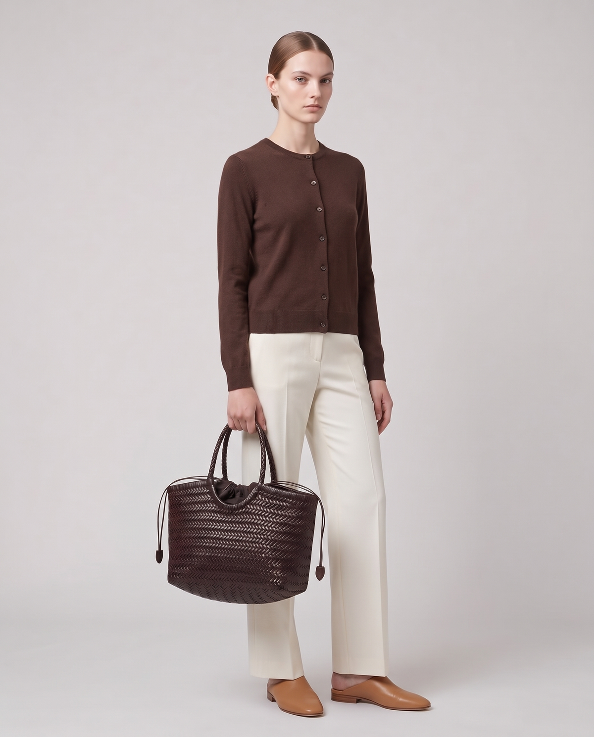 Model holding the Valentina Lecce bag in Chocolate, full length