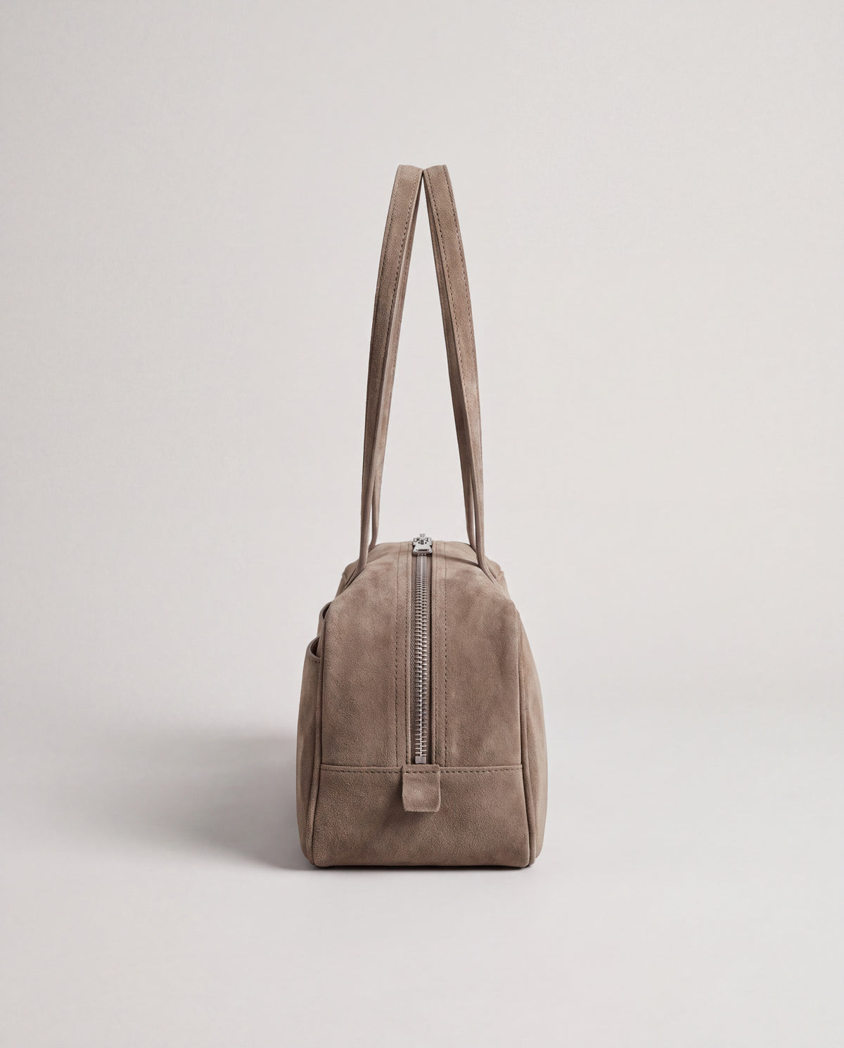 Valentina Linea suede shoulder bag in Taupe, side view showing the end zip