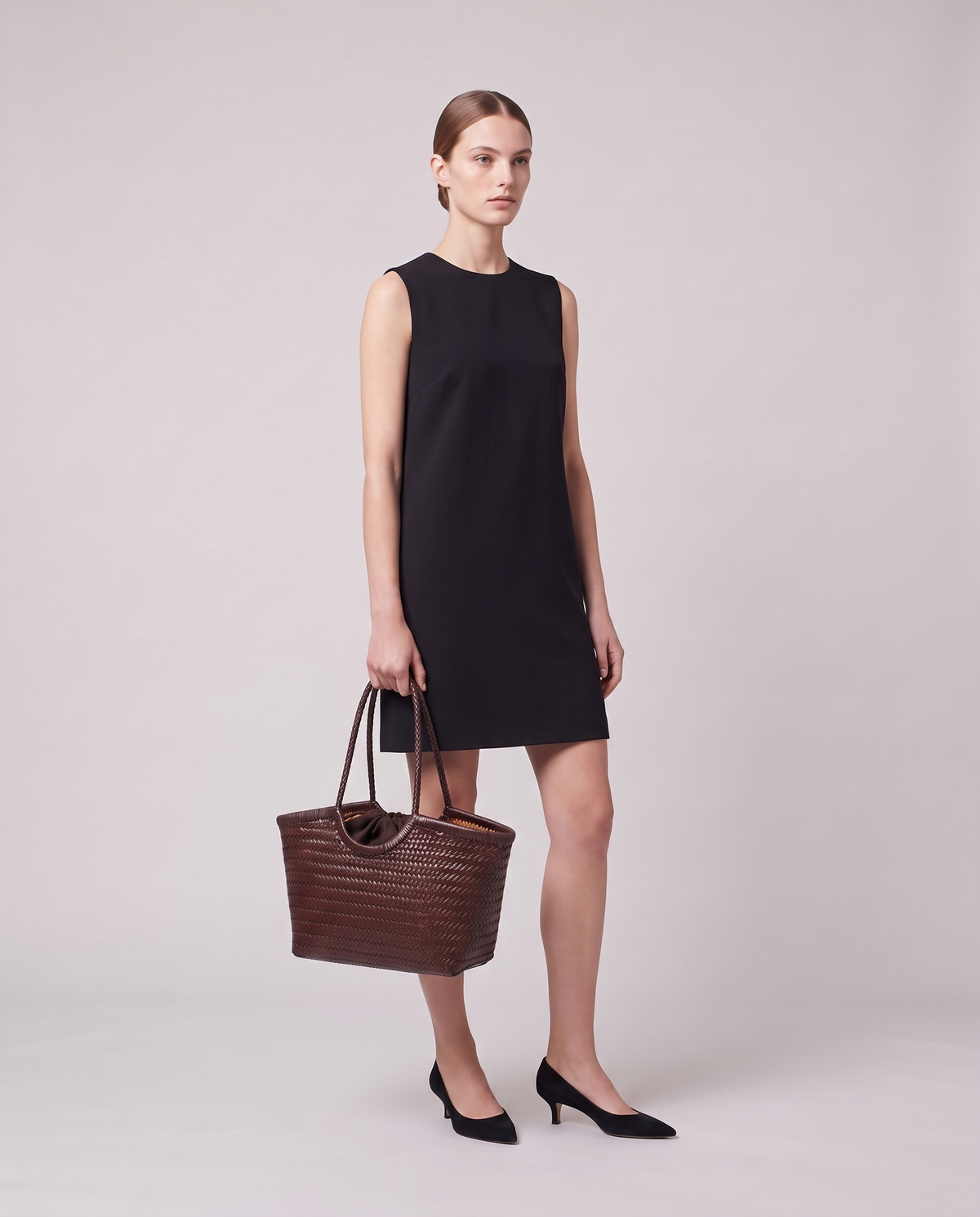 Model holding the Valentina Matera Small bag in Brown, full length