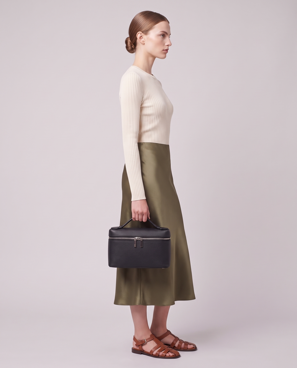 Model holding the Valentina Orvieto Small top-handle bag in Chocolate leather, full length