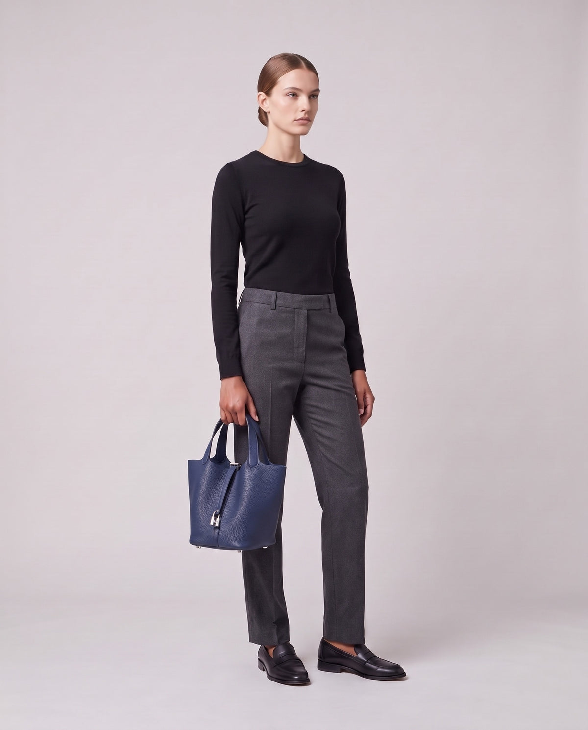 Model holding the Valentina Ostuni Large bag in Navy, full length