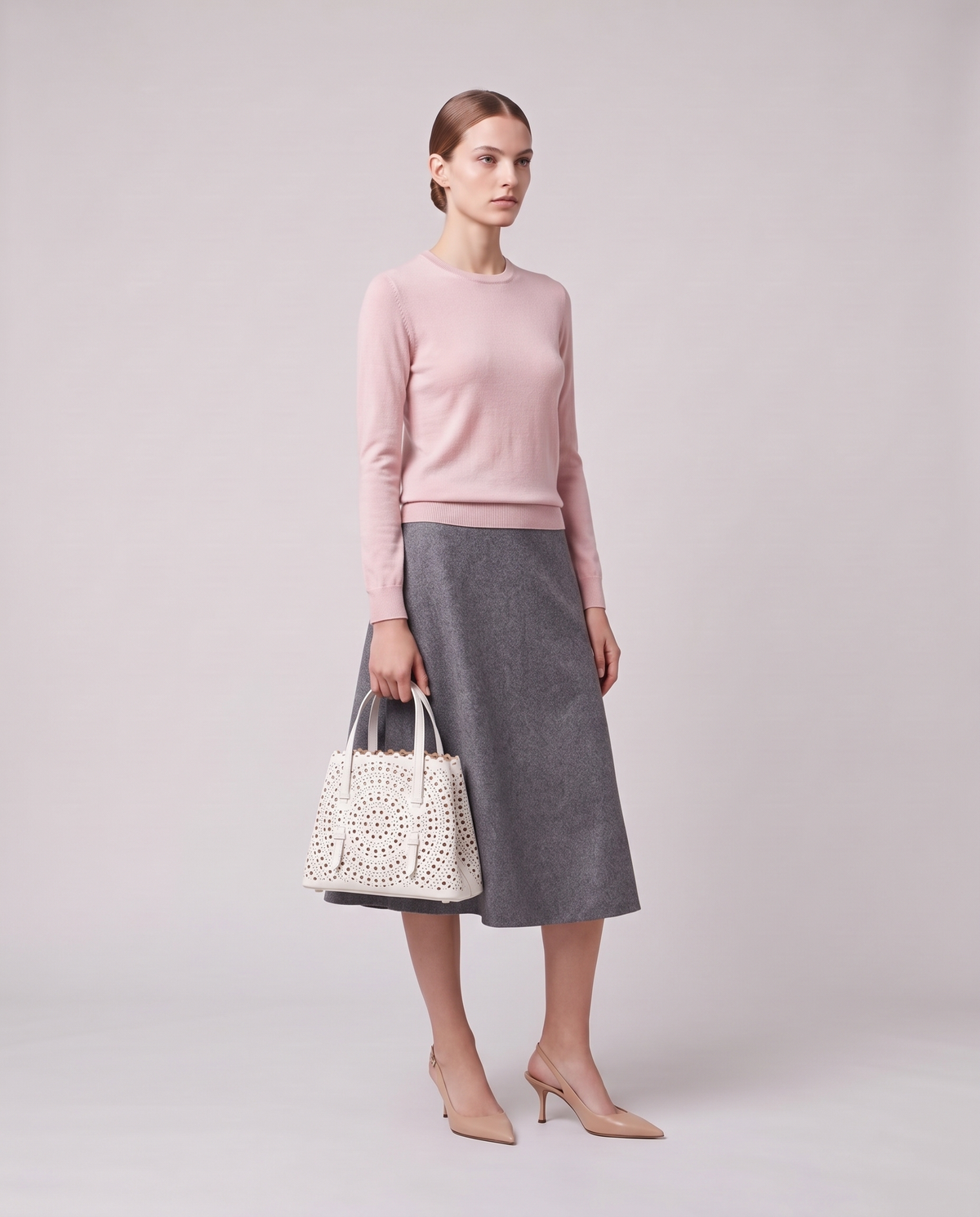 Model holding the Valentina Urbino Medium bag in White, full length