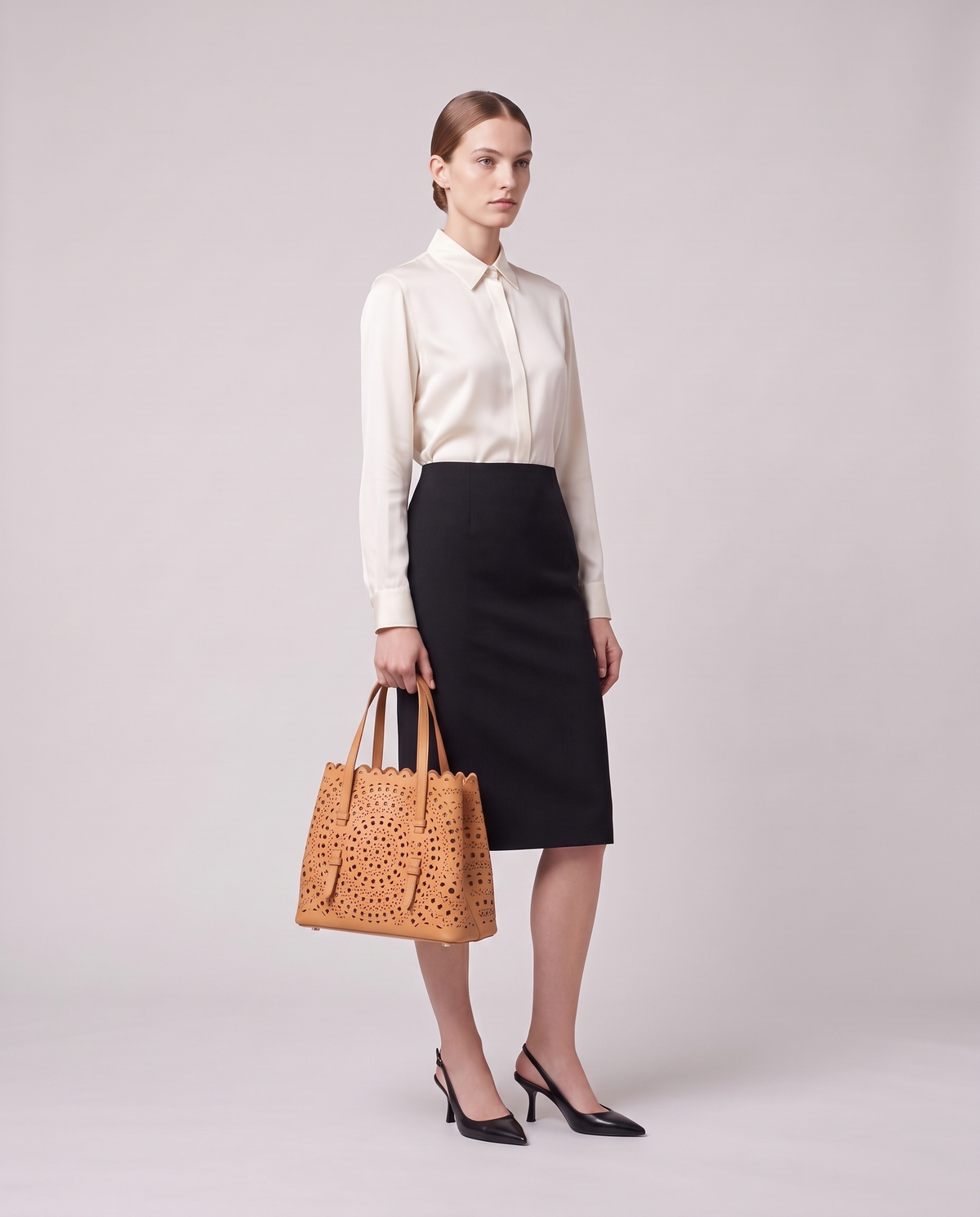 Model holding the Valentina Urbino Small bag in Apricot, full length
