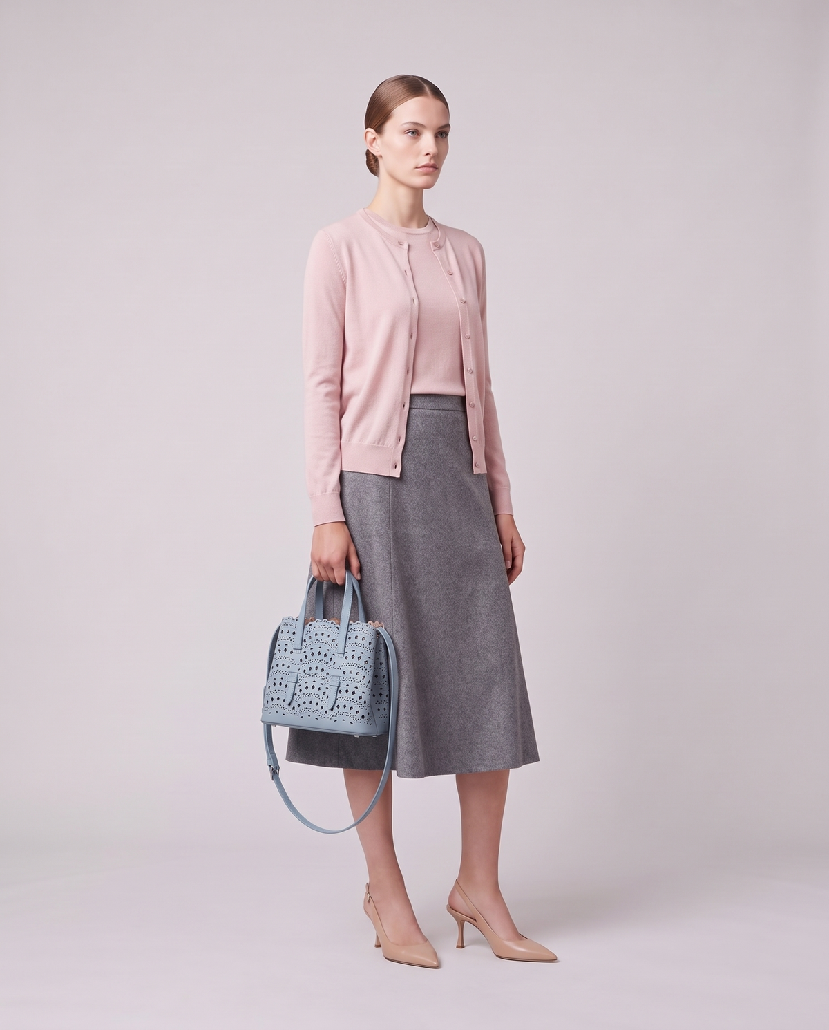 Model holding the Valentina Urbino Small bag in Sky, full length
