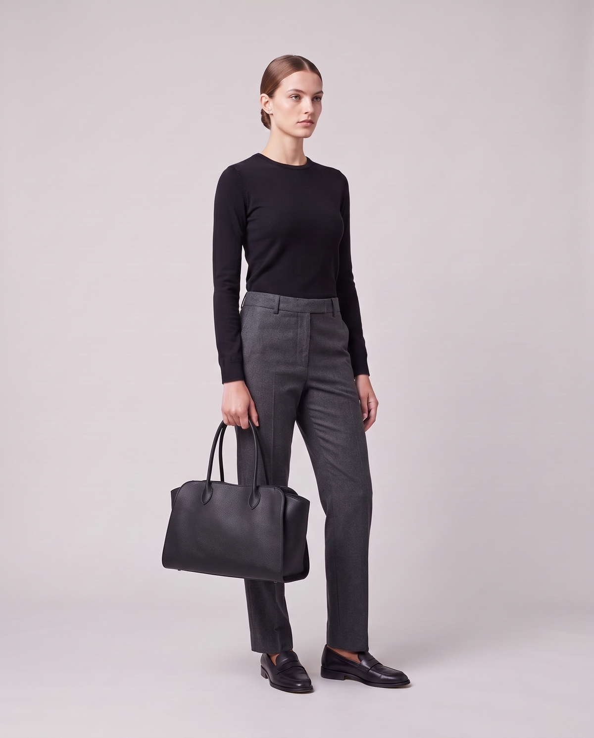 Model holding the Valentina Volta Small bag in Black, full length