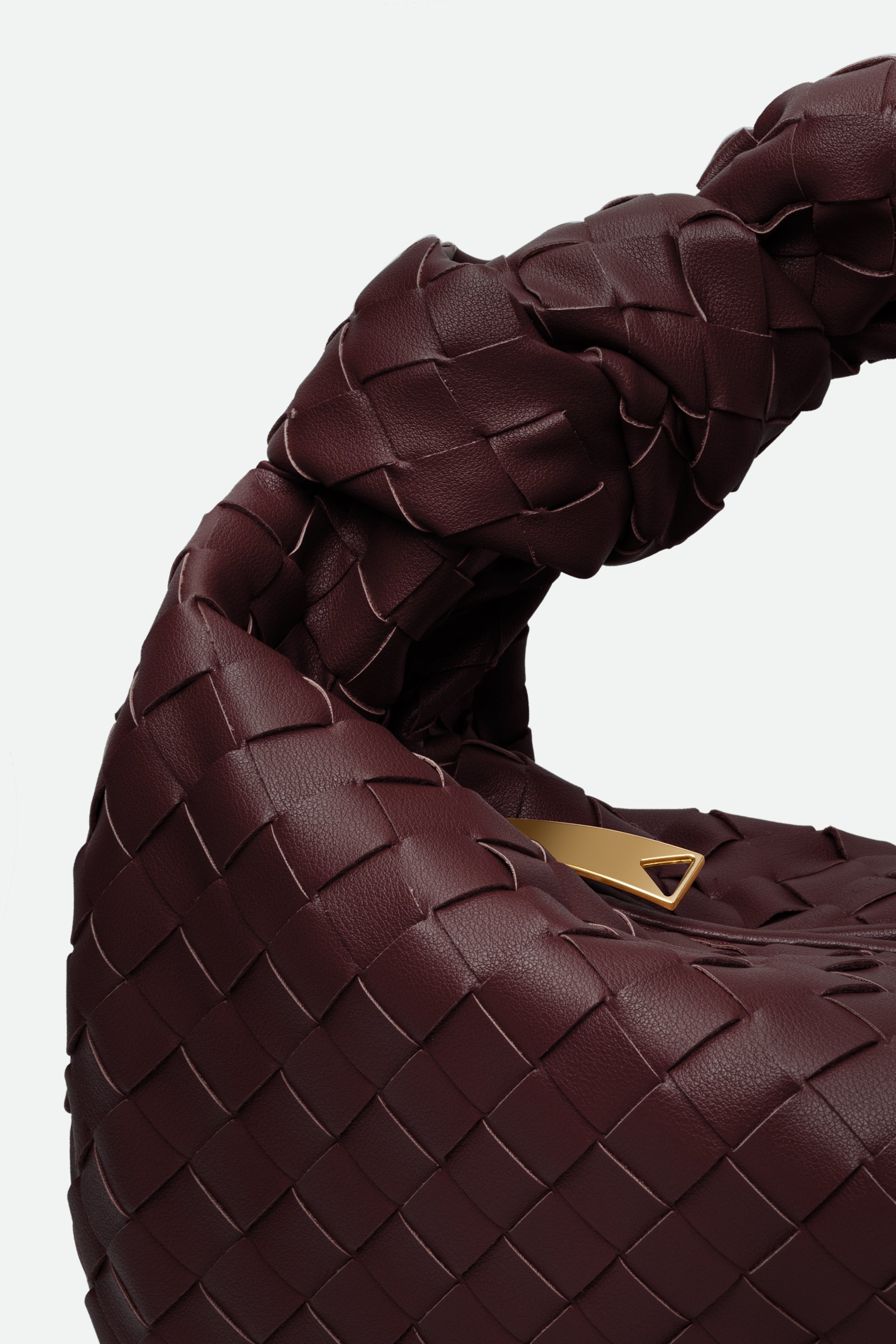 Close-up of a wine red woven handbag with a gold tag on a light gray background